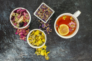 herbal-tea-near-bowls-dry-flowers-grey-3248152